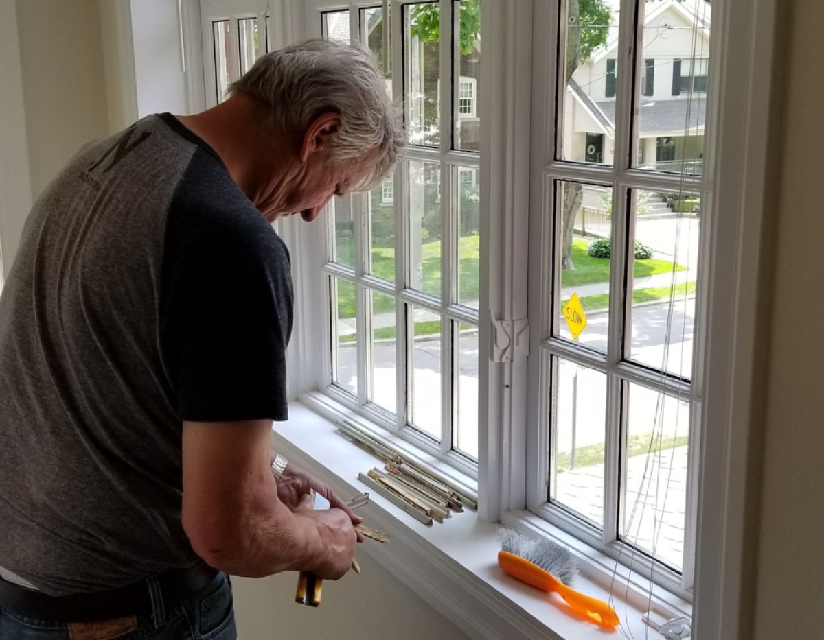 Cloudy Then Clear technician replacing a sealed glass unit in a Toronto home