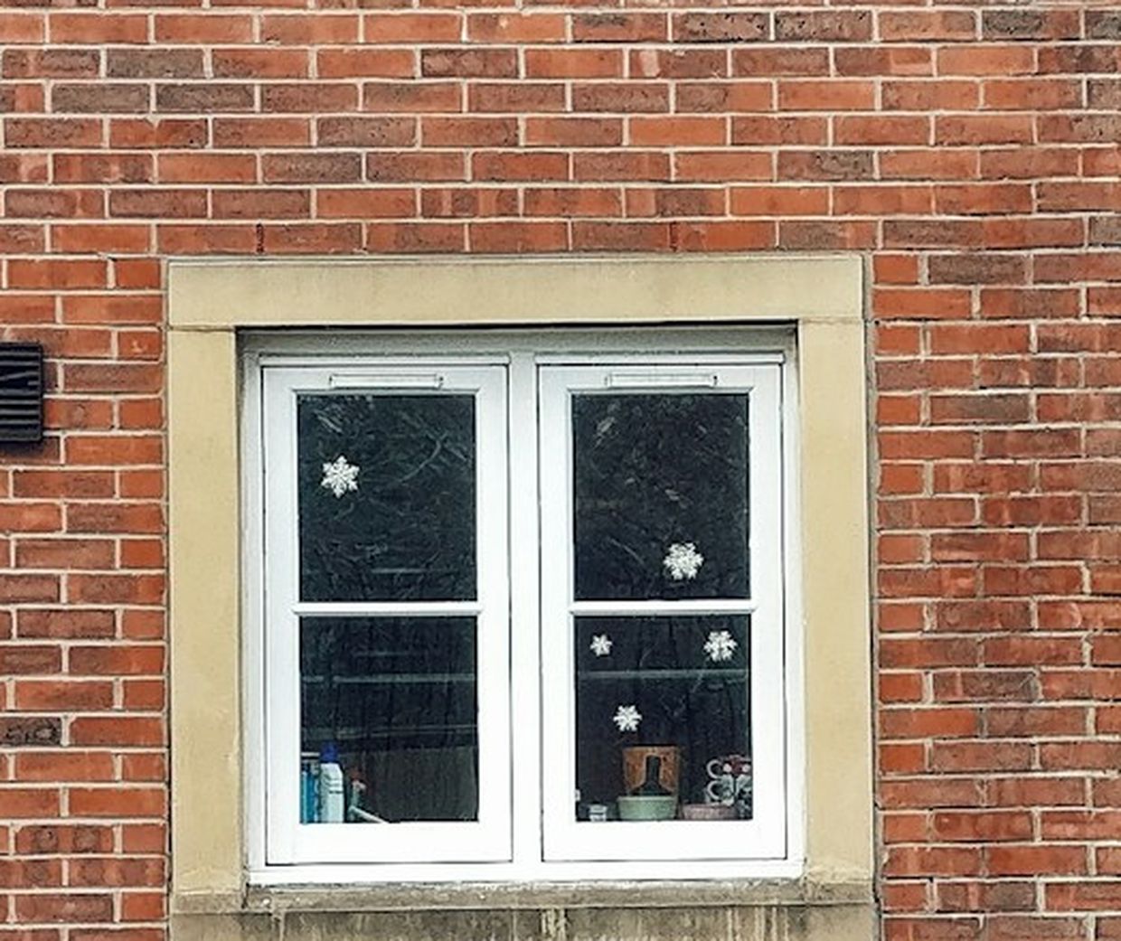 A standard vinyl window installed brick to brick in a home's exterior wall